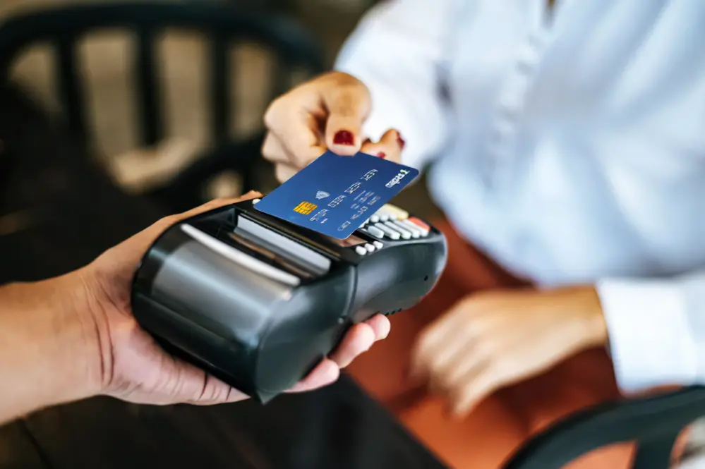 A customer uses a card for payment at a point-of-sale (POS). ATM card holders can use only chip cards instead of magnetic cards at many banks. VNA/VNS Photo