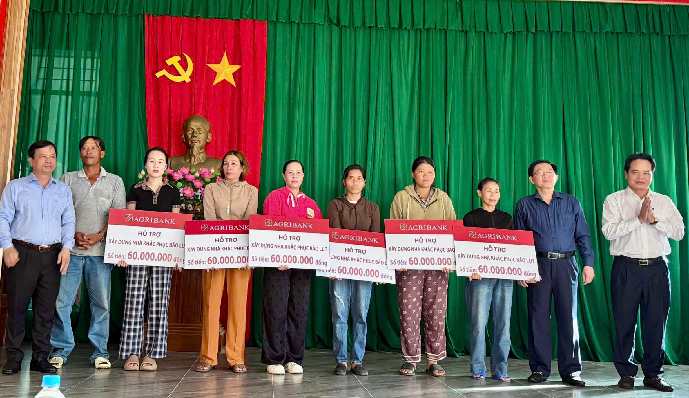 Ông Vương Hồng Lĩnh - Phó Tổng Giám đốc Agribank (ngoài cùng bên phải) trao hỗ trợ xây dựng nhà khắc phục bão lụt