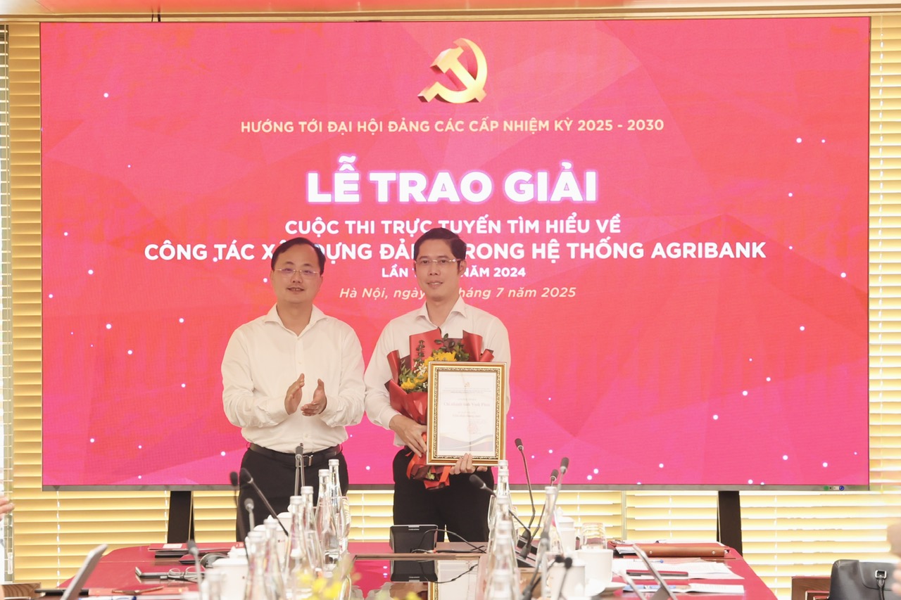 Đồng chí Tô Huy Vũ, Bí thư Đảng ủy, Chủ tịch HĐTV trao giải và tặng hoa chúc mừng Agribank Chi nhánh Vĩnh Phúc - đơn vị giành giải Nhất của cuộc thi