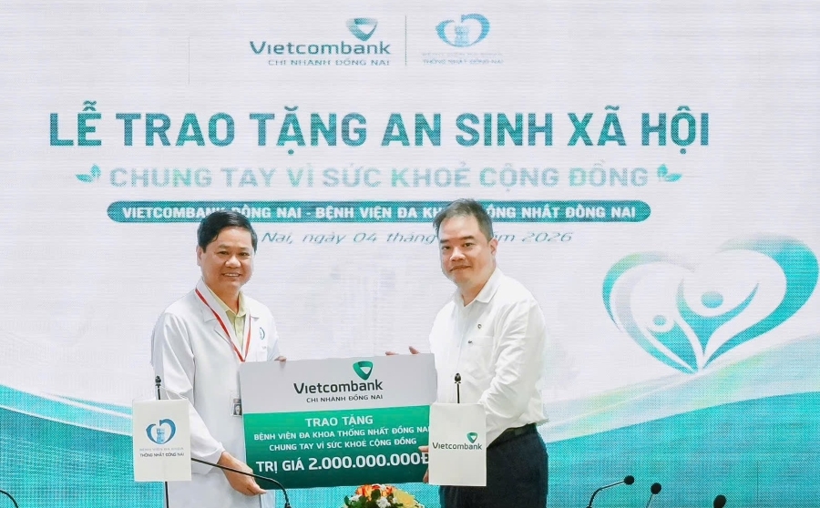 Đại diện Vietcombank Đồng Nai (bên phải) trao tặng chương trình an sinh xã hội với tổng giá trị 2 tỷ đồng