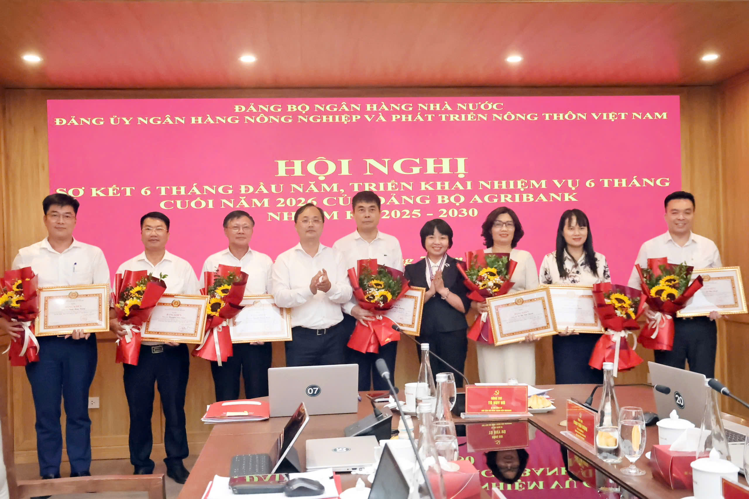 Đồng chí Lê Thị Mai Hương, Phó Bí thư chuyên trách Đảng ủy Ngân hàng Nhà nước và đồng chí Tô Huy Vũ, Bí thư Đảng ủy, Chủ tịch HĐTV Agribank trao Bằng khen của Ban Thường vụ Đảng ủy Chính phủ cho các đảng viên đạt tiêu chuẩn “Hoàn thành xuất sắc nhiệm vụ” 05 năm liên tục (2021-2025)